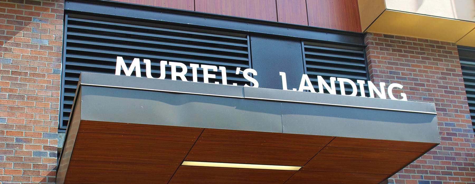 Leasing office entrance with a sign that says Muriel's Landing